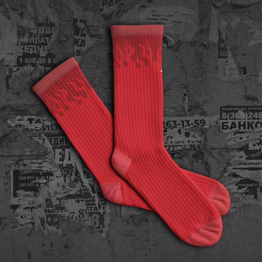 Red socks on a dark textured background with 'NEW DROP' text.