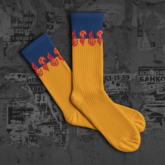 Yellow and blue socks with flame design on a textured dark background