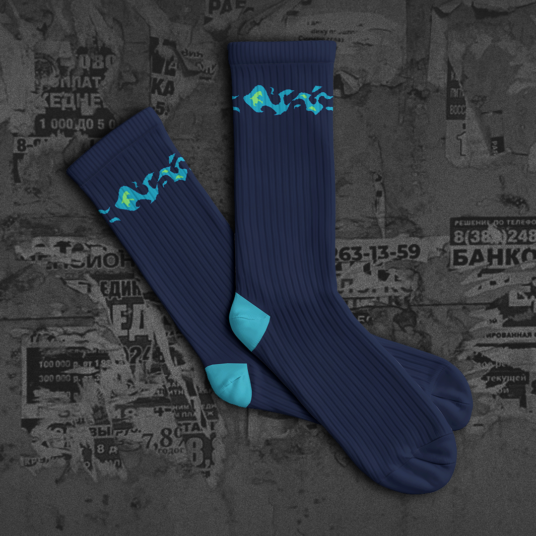 Blue socks with green designs on a textured dark background with 'NEW DROP' text.