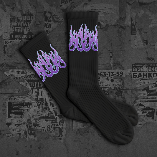 Black socks with purple flame design on a textured background with 'NEW DROP' text.